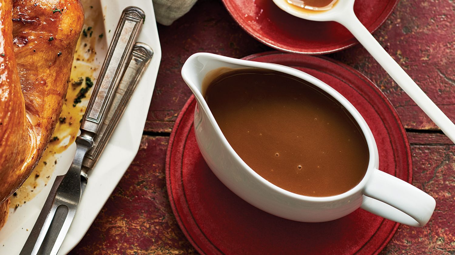 topdown view of gravy boat on a red plate