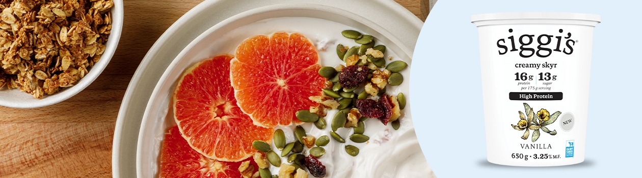 Granola and yogurt dish topped with a slice of grapefruit